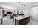 Open concept kitchen island with seating overlooking the dining and living spaces at 868 W Desert Glen Dr, San Tan Valley, AZ 85143