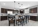 Spacious kitchen with dark cabinetry, a breakfast bar, and stainless steel appliances at 868 W Desert Glen Dr, San Tan Valley, AZ 85143