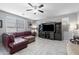 Cozy living room featuring a leather couch, a ceiling fan, and a large entertainment center at 868 W Desert Glen Dr, San Tan Valley, AZ 85143