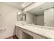 Bright bathroom with a long vanity and a combined shower-tub at 8816 W Catalina Dr, Phoenix, AZ 85037