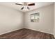 Bedroom with dark vinyl floors, neutral walls, and a ceiling fan at 8816 W Catalina Dr, Phoenix, AZ 85037