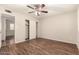 Cozy bedroom showcasing wood floors, a neutral color scheme, a ceiling fan, and closet at 8816 W Catalina Dr, Phoenix, AZ 85037