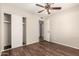 Bedroom with dark floors, ceiling fan and a sliding door closet at 8816 W Catalina Dr, Phoenix, AZ 85037