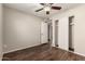 Bedroom with dark vinyl floors, closet and ceiling fan at 8816 W Catalina Dr, Phoenix, AZ 85037