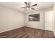 Bedroom with wood floors, a neutral color scheme, ceiling fan, and bright window at 8816 W Catalina Dr, Phoenix, AZ 85037