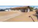 View of the home's exterior showcasing the driveway, covered parking, and low-maintenance landscaping at 8816 W Catalina Dr, Phoenix, AZ 85037