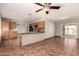 Open kitchen view with tile floors, wood cabinets, and a sliding glass door to the backyard at 8816 W Catalina Dr, Phoenix, AZ 85037