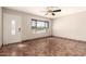 Bright living room with tile flooring, a large window, and ceiling fan at 8816 W Catalina Dr, Phoenix, AZ 85037