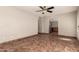 Open-concept living space featuring tile floors, a ceiling fan, and easy access to the kitchen at 8816 W Catalina Dr, Phoenix, AZ 85037