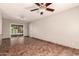 Spacious living room with tile floors, a sliding glass door and neutral paint at 8816 W Catalina Dr, Phoenix, AZ 85037