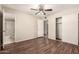 Bedroom featuring wood floors, a neutral color scheme, walk in closet, and access to the bathroom at 8816 W Catalina Dr, Phoenix, AZ 85037