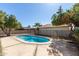 Backyard view of a refreshing fenced swimming pool surrounded by mature trees at 8816 W Catalina Dr, Phoenix, AZ 85037