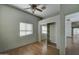 Bedroom with ceiling fan, closet with sliding mirror doors, and wood-look flooring at 934 E Carlise Rd, Phoenix, AZ 85086