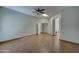 Bedroom with wood floors, ceiling fan, skylight and entry into a walk-in closet and bathroom at 934 E Carlise Rd, Phoenix, AZ 85086