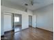 Bedroom with ceiling fan, closet with sliding mirror doors, and wood-look flooring at 934 E Carlise Rd, Phoenix, AZ 85086