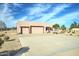 This home features a large driveway and a three-car garage, along with a desert landscape and stucco exterior at 934 E Carlise Rd, Phoenix, AZ 85086