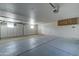 Spacious garage with plenty of storage and shelving, painted floors and walls at 934 E Carlise Rd, Phoenix, AZ 85086