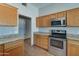 Bright kitchen featuring granite countertops, stainless steel appliances, and ample storage space in wood cabinetry at 934 E Carlise Rd, Phoenix, AZ 85086