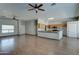 Spacious living room featuring wood flooring and a view into the kitchen and breakfast bar at 934 E Carlise Rd, Phoenix, AZ 85086