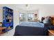 Bright bedroom with a work space, balcony, and a blue bookshelf against white walls at 10401 N Saguaro Blvd # 104, Fountain Hills, AZ 85268