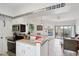 Open kitchen featuring stainless steel appliances and a breakfast bar leading to living area at 10401 N Saguaro Blvd # 104, Fountain Hills, AZ 85268