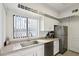 Bright kitchen with white cabinets, stainless steel appliances, and a window overlooking the outdoors at 10401 N Saguaro Blvd # 104, Fountain Hills, AZ 85268