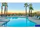 Community pool with palm trees and mountain views creating a relaxing desert oasis at 10401 N Saguaro Blvd # 104, Fountain Hills, AZ 85268