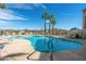 Inviting community pool surrounded by lounge chairs, desert landscaping and mountain views at 10401 N Saguaro Blvd # 104, Fountain Hills, AZ 85268
