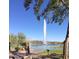Scenic view of a lake featuring a large fountain with a beautiful desert landscape backdrop at 10401 N Saguaro Blvd # 104, Fountain Hills, AZ 85268