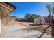Spacious backyard with a concrete patio, storage shed, and potential for landscaping at 10533 W Lawrence Ln, Peoria, AZ 85345