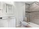 Stylish bathroom features a granite countertop vanity, toilet, and tiled walk in shower at 10533 W Lawrence Ln, Peoria, AZ 85345