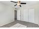 Bedroom featuring a ceiling fan, carpet flooring and double door closet at 10533 W Lawrence Ln, Peoria, AZ 85345