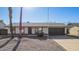 Well-kept residence featuring a dark garage door, contrasted by light exterior paint, creating curb appeal at 10533 W Lawrence Ln, Peoria, AZ 85345