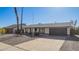 Charming single-level home with a dark-toned garage door, offering a welcoming facade and ample parking space at 10533 W Lawrence Ln, Peoria, AZ 85345
