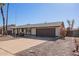 Charming one-story home with a driveway leading to an attached garage and desert landscaping at 10533 W Lawrence Ln, Peoria, AZ 85345