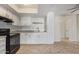 Modern kitchen with ample cabinets, granite countertops, and appliances seamlessly flows into the living area at 10533 W Lawrence Ln, Peoria, AZ 85345
