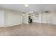 Inviting living room features tile flooring, neutral walls, and an adjoining kitchen area at 10533 W Lawrence Ln, Peoria, AZ 85345