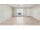 Sunlit open living space with tiled floors, a window view, and a modern ceiling light at 10533 W Lawrence Ln, Peoria, AZ 85345