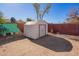 Backyard features a storage shed with dirt landscaping and some greenery at 10533 W Lawrence Ln, Peoria, AZ 85345