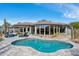 Panoramic view of the backyard with a pool, desert landscaping, and expansive windows for natural light at 10951 E Mirasol Cir, Scottsdale, AZ 85255