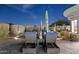 Backyard patio with lounge chairs, desert landscaping, and privacy hedges at 10951 E Mirasol Cir, Scottsdale, AZ 85255
