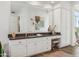 Bathroom vanity with a large mirror, ample storage, and a cozy seating area at 10951 E Mirasol Cir, Scottsdale, AZ 85255