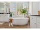 Bright bathroom featuring a freestanding tub, wooden accents, natural light, and modern fixtures at 10951 E Mirasol Cir, Scottsdale, AZ 85255