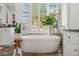 Bathroom featuring a freestanding tub, wooden accents, natural light, and modern fixtures at 10951 E Mirasol Cir, Scottsdale, AZ 85255