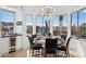 Dining room with modern chandelier, desert views, and table set for six at 10951 E Mirasol Cir, Scottsdale, AZ 85255