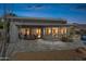 Expansive backyard patio featuring desert landscaping, curved architecture, and sliding glass doors at 10951 E Mirasol Cir, Scottsdale, AZ 85255