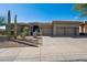 Attractive desert home with native landscaping, three car garage, and a desert xeriscape at 10951 E Mirasol Cir, Scottsdale, AZ 85255