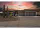 Stunning desert home with three car garage and mature landscaping in the front yard at 10951 E Mirasol Cir, Scottsdale, AZ 85255