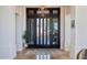 Elegant front door with transom windows leading to the home's entry and interior spaces at 10951 E Mirasol Cir, Scottsdale, AZ 85255