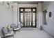 Inviting front entrance with chairs, pillows, and décor elements in a desert themed courtyard at 10951 E Mirasol Cir, Scottsdale, AZ 85255